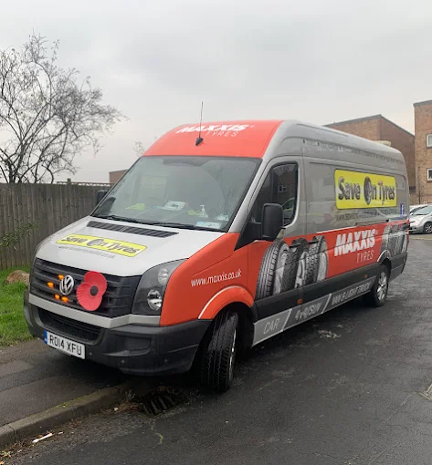 Save On Tyres mobile tyre fitting Swindon service van replacing a tyre at a customer's home.