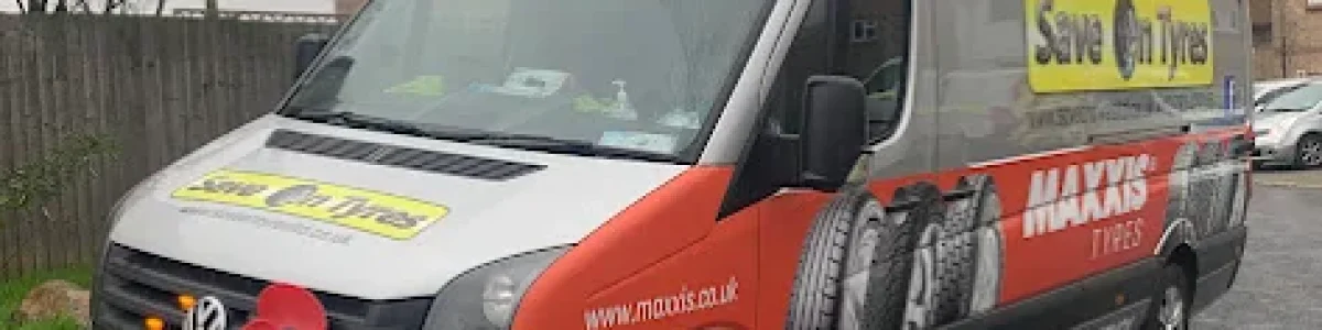 Save On Tyres mobile tyre fitting Swindon service van replacing a tyre at a customer's home.